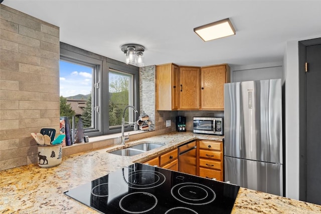 2515 Apres Ski Way Unit 5, Steamboat Springs, CO 80487 - kitchen with stainless steel appliances, a sink, backsplash, and light stone counters