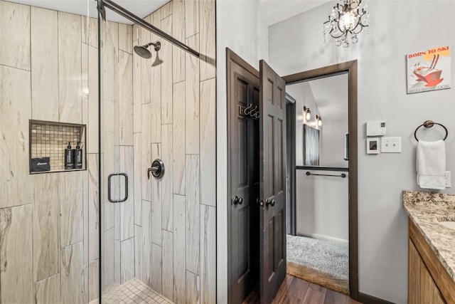2515 Apres Ski Way Unit 5, Steamboat Springs, CO 80487 - bathroom with a stall shower, wood finished floors, and vanity