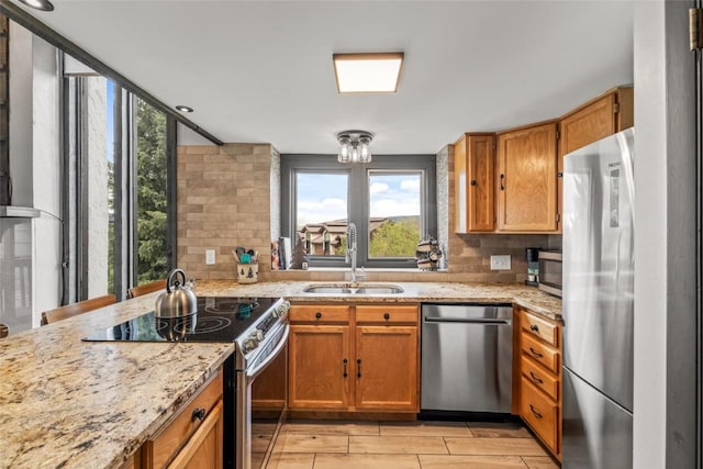 2515 Apres Ski Way Unit 5, Steamboat Springs, CO 80487 - kitchen with stainless steel appliances, a sink, tasteful backsplash, and light stone countertops