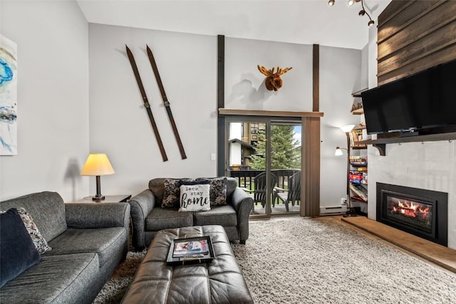 2515 Apres Ski Way Unit 5, Steamboat Springs, CO 80487 - living area with a tile fireplace, vaulted ceiling, and baseboard heating