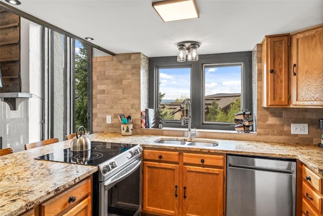 2515 Apres Ski Way Unit 5, Steamboat Springs, CO 80487 - kitchen featuring appliances with stainless steel finishes, a sink, healthy amount of natural light, and tasteful backsplash