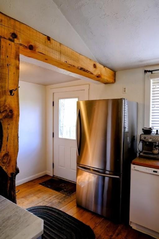 436 Clifton Ave, Yampa, CO 80483 - kitchen with freestanding refrigerator, white dishwasher, hardwood / wood-style flooring, vaulted ceiling, and baseboards