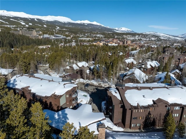 snowy aerial view with a residential view and a mountain view