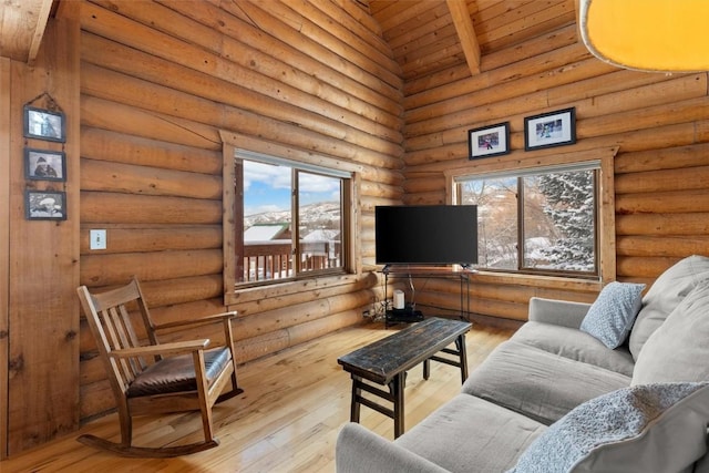 625 Amethyst Dr, Steamboat Springs, CO 80487 - living area with log walls, wood ceiling with exposed beams, hardwood / wood-style flooring, and high vaulted ceiling