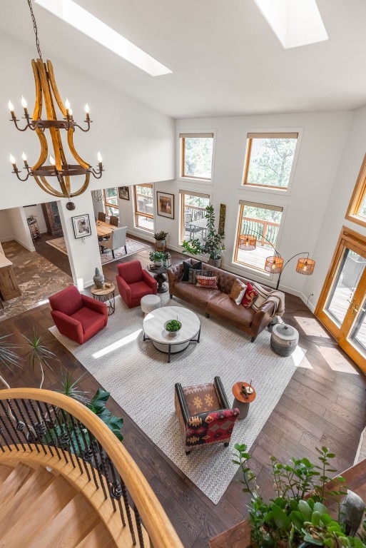 192 Nova Dr, Pine, CO 80470 - living area with a skylight, wood finished floors, a chandelier, and a high ceiling