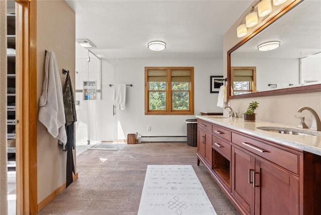 192 Nova Dr, Pine, CO 80470 - bathroom featuring baseboard heating and double vanity