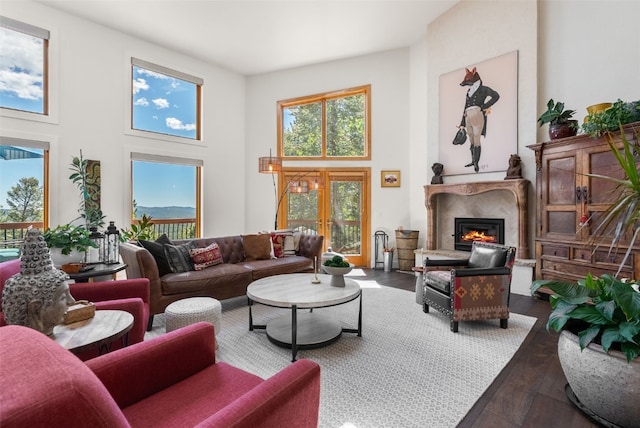 192 Nova Dr, Pine, CO 80470 - living room featuring hardwood / wood-style floors, a high ceiling, and a premium fireplace