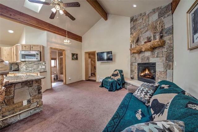 61 Pine Cir, Breckenridge, CO 80424 - living room with beam ceiling, a stone fireplace, light carpet, ceiling fan, and high vaulted ceiling