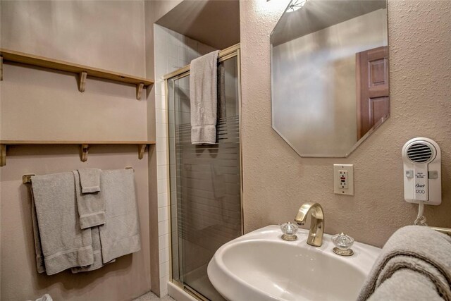 61 Pine Cir, Breckenridge, CO 80424 - full bathroom with a textured wall, a sink, and a stall shower