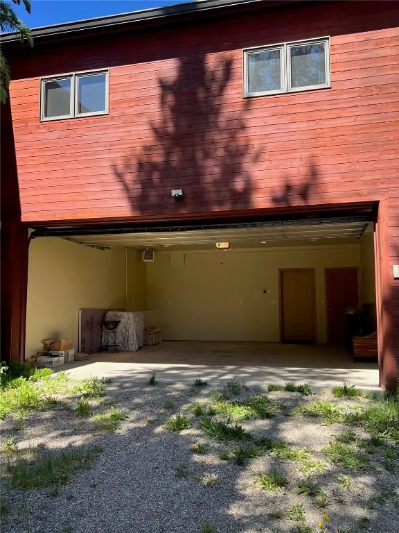 61 Pine Cir, Breckenridge, CO 80424 - back of property with an attached garage and a patio area