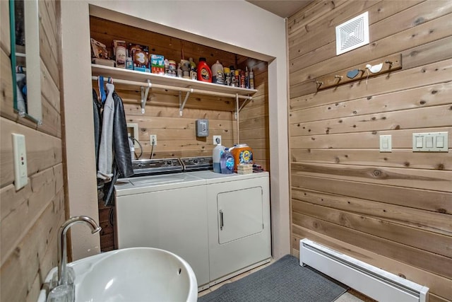 61 Pine Cir, Breckenridge, CO 80424 - laundry area featuring washer and clothes dryer, wooden walls, and a baseboard radiator