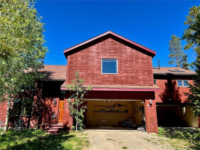 61 Pine Cir, Breckenridge, CO 80424 - view of front of house with a garage, driveway, and a shingled roof