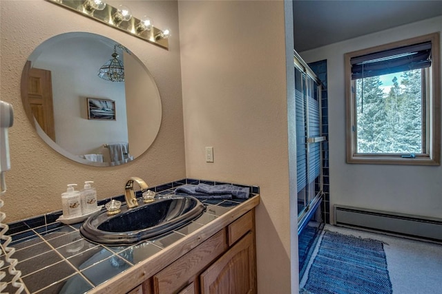 61 Pine Cir, Breckenridge, CO 80424 - bathroom featuring a baseboard heating unit, vanity, and a textured wall