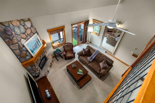 435 Ore House Plz Unit 301, Steamboat Springs, CO 80487 - living room with carpet flooring, a fireplace, and plenty of natural light