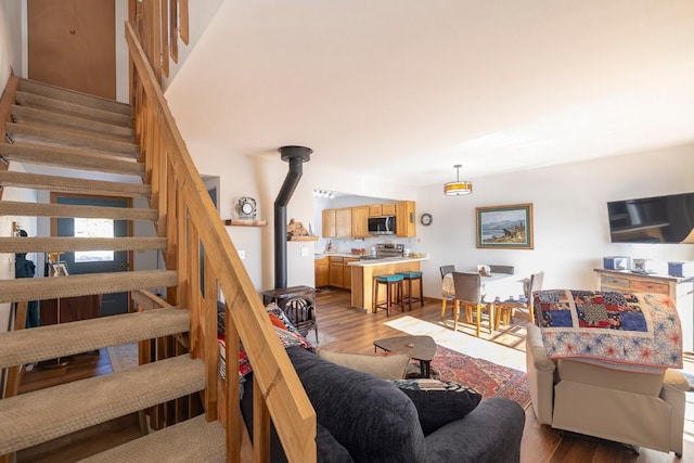 122 Gcr 442 Unit 2B, Grand Lake, CO 80447 - living room with stairway, a wood stove, and wood finished floors