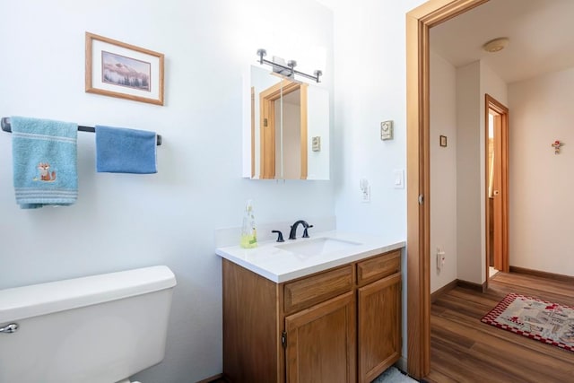 122 Gcr 442 Unit 2B, Grand Lake, CO 80447 - half bathroom with toilet, vanity, wood finished floors, and baseboards