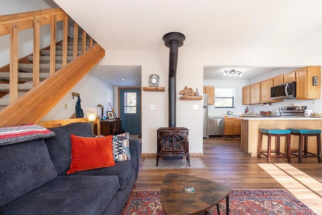 122 Gcr 442 Unit 2B, Grand Lake, CO 80447 - living area featuring stairway, dark wood-style flooring, and a wood stove