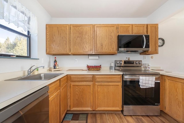 122 Gcr 442 Unit 2B, Grand Lake, CO 80447 - kitchen featuring appliances with stainless steel finishes, wood finished floors, a sink, and light countertops