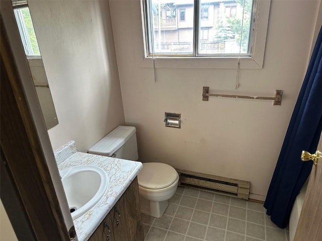 bathroom featuring tile patterned flooring, a baseboard radiator, toilet, and vanity
