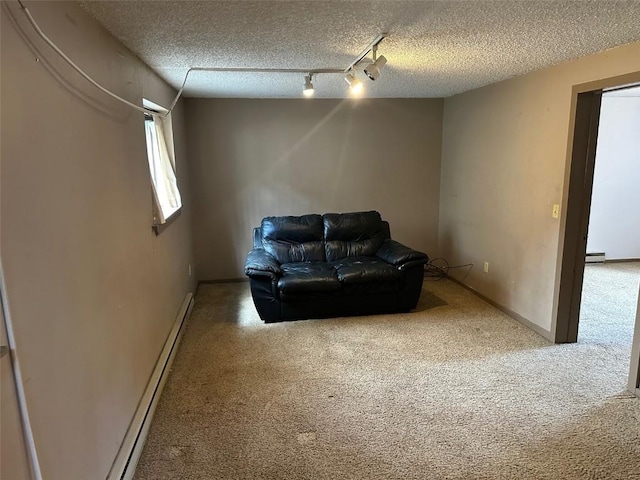 interior space featuring carpet flooring, a textured ceiling, and a baseboard radiator