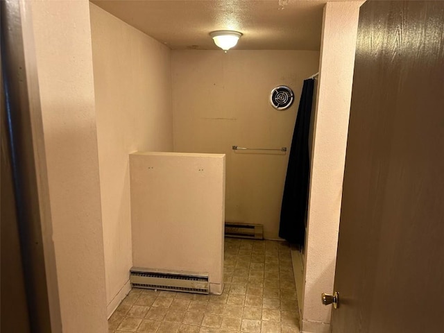 washroom with a baseboard heating unit