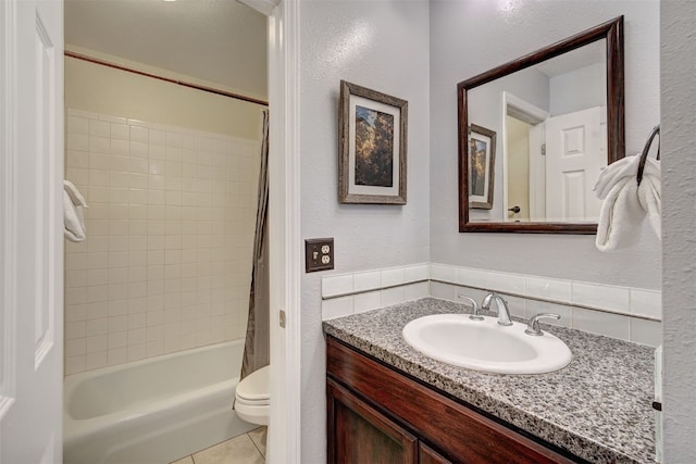 1153 Straight Creek Dr Unit 204, Dillon, CO 80435 - bathroom featuring vanity, shower / bath combo with shower curtain, toilet, a textured wall, and tile patterned floors