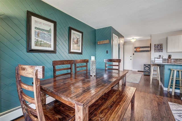 1153 Straight Creek Dr Unit 204, Dillon, CO 80435 - dining area with a baseboard radiator, dark wood finished floors, and baseboards
