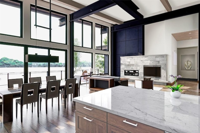 971 Steamboat Blvd, Steamboat Springs, CO 80487 - kitchen featuring a towering ceiling, dark wood finished floors, beamed ceiling, light stone countertops, and open floor plan