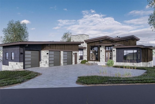 971 Steamboat Blvd, Steamboat Springs, CO 80487 - contemporary house with stone siding, decorative driveway, and an attached garage