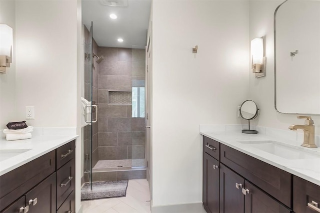 bathroom featuring a sink, a stall shower, recessed lighting, and two vanities