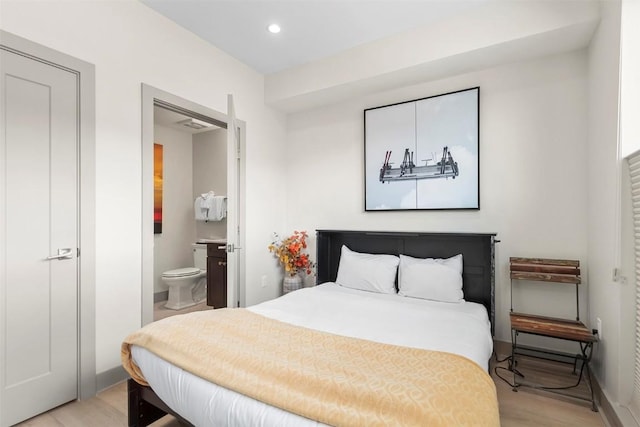 bedroom featuring recessed lighting, baseboards, light wood finished floors, and connected bathroom