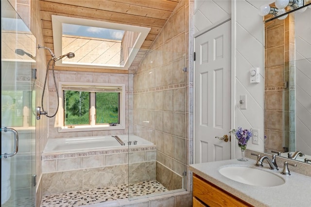 31650 Mt Werner Rd, Steamboat Springs, CO 80487 - bathroom featuring vanity, a shower stall, tiled tub, vaulted ceiling, and tile walls