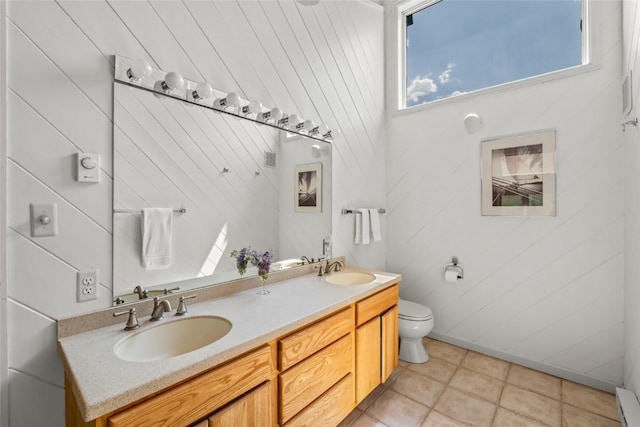 31650 Mt Werner Rd, Steamboat Springs, CO 80487 - bathroom with double vanity, tile patterned floors, wooden walls, and a baseboard heating unit
