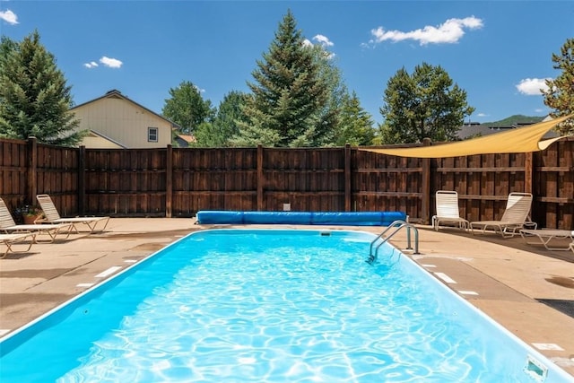 view of pool featuring a fenced in pool, fence, and a patio