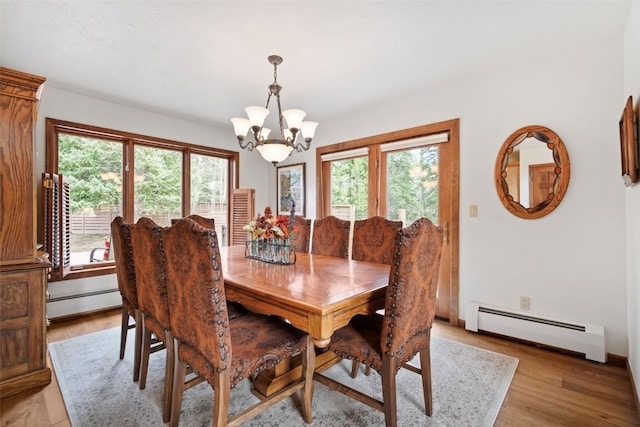 112 N Pine St, Breckenridge, CO 80424 - dining space featuring baseboard heating, a chandelier, and light wood-style flooring