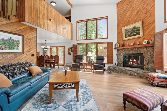 112 N Pine St, Breckenridge, CO 80424 - living area with a towering ceiling, wood walls, a chandelier, wood finished floors, and a fireplace