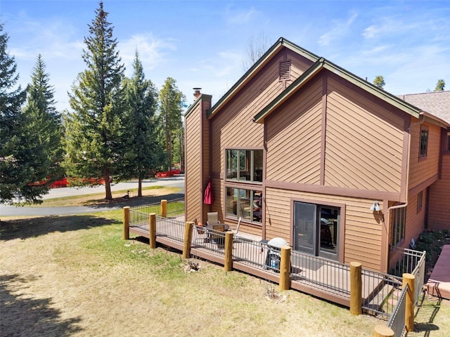 112 N Pine St, Breckenridge, CO 80424 - view of side of home featuring a chimney, a wooden deck, and a yard