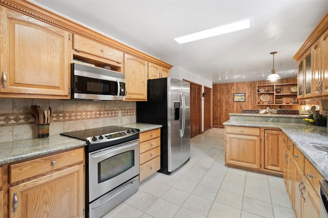 112 N Pine St, Breckenridge, CO 80424 - kitchen with appliances with stainless steel finishes, tasteful backsplash, light tile patterned flooring, rail lighting, and a peninsula