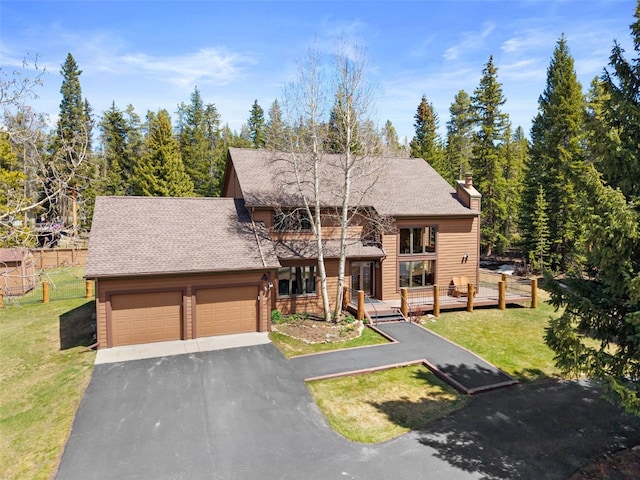 112 N Pine St, Breckenridge, CO 80424 - view of front of property featuring a garage, a front lawn, asphalt driveway, a chimney, and a shingled roof