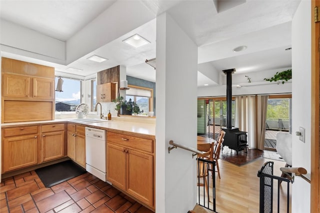 71 Barking Dog Rd, Silverthorne, CO 80498 - kitchen with dishwasher, a sink, a wood stove, and light countertops