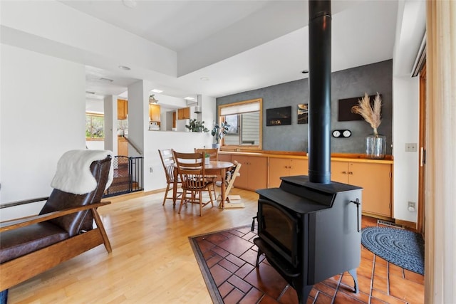 71 Barking Dog Rd, Silverthorne, CO 80498 - living area with a wood stove, light wood-type flooring, and a baseboard heating unit