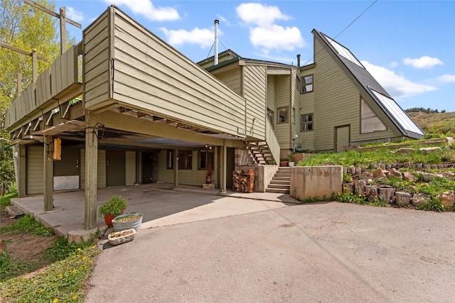 71 Barking Dog Rd, Silverthorne, CO 80498 - back of house featuring stairway, asphalt driveway, and a carport
