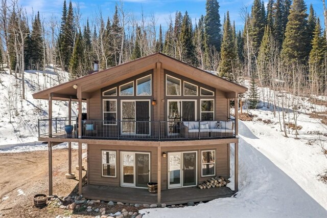 58195 Jupiter Pl, Clark, CO 80428 - snow covered rear of property with a wooded view and a balcony