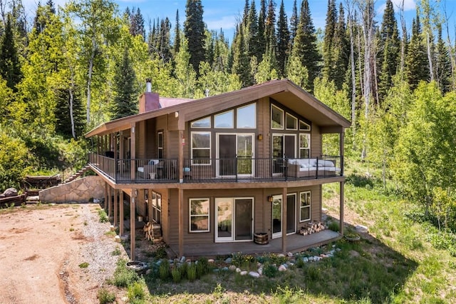 58195 Jupiter Pl, Clark, CO 80428 - view of front of property featuring a forest view, a chimney, stairs, and a wooden deck
