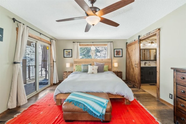 58195 Jupiter Pl, Clark, CO 80428 - bedroom featuring a barn door, wood finished floors, a ceiling fan, access to outside, and ensuite bathroom