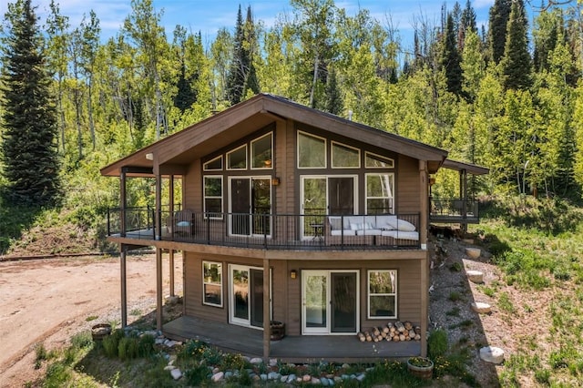 58195 Jupiter Pl, Clark, CO 80428 - back of property featuring a balcony and a view of trees