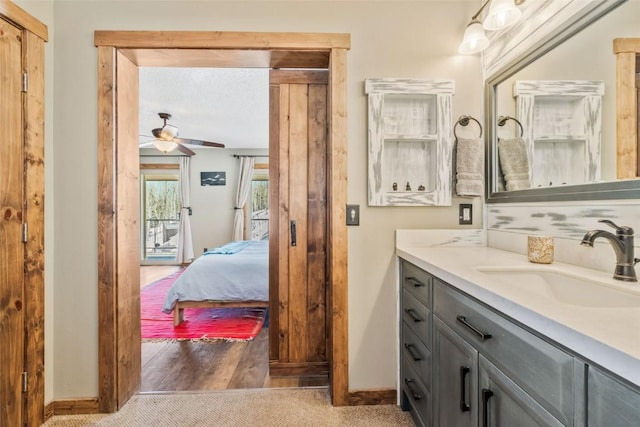 58195 Jupiter Pl, Clark, CO 80428 - bathroom with wood finished floors, a ceiling fan, vanity, baseboards, and ensuite bathroom