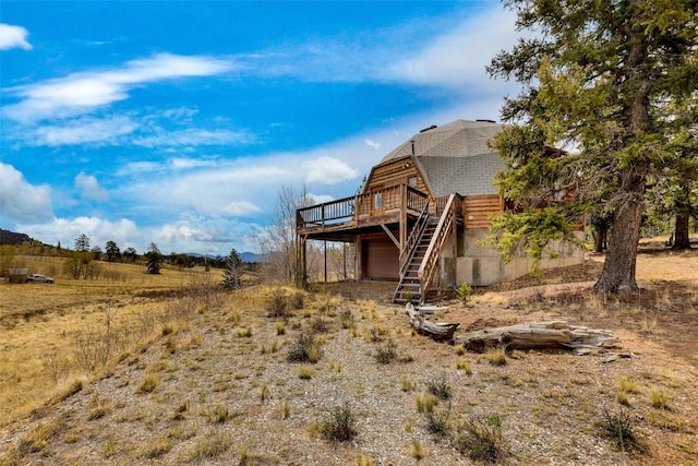 902 Hawk Way, Como, CO 80456 - rear view of property featuring a wooden deck, a gambrel roof, stairs, and a garage