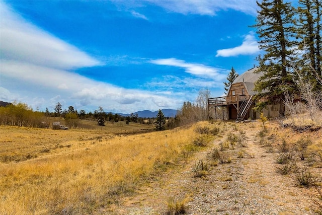 902 Hawk Way, Como, CO 80456 - view of yard with a deck with mountain view, stairway, and a view of countryside