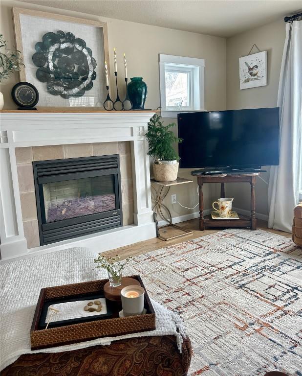 38 Huckleberry Grn, Breckenridge, CO 80424 - living area featuring a tiled fireplace and wood finished floors